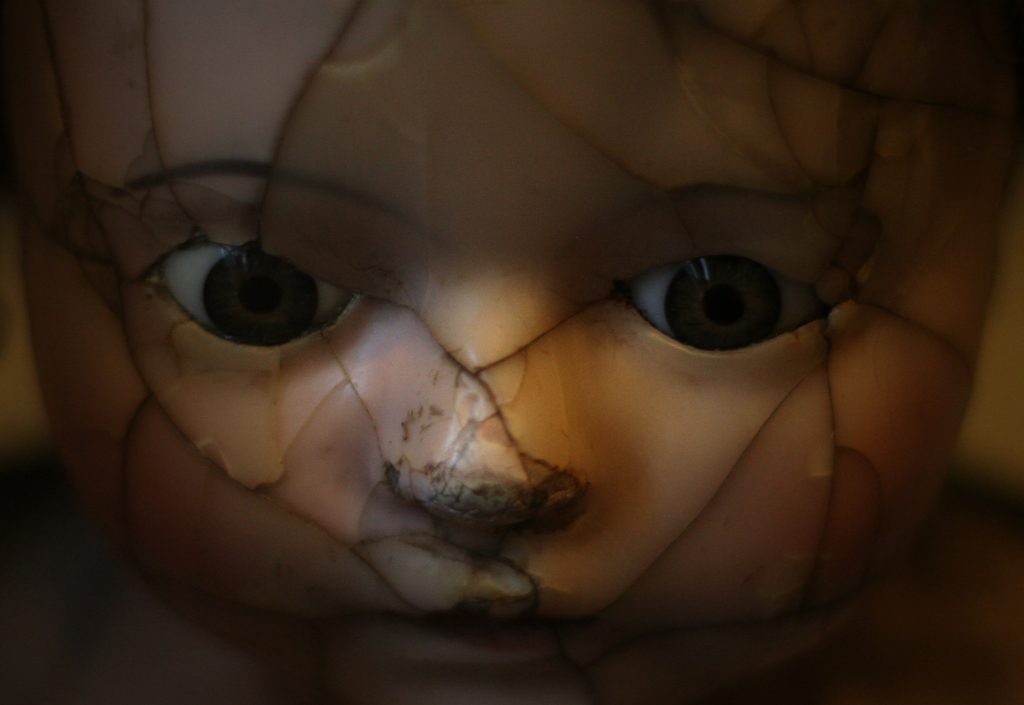 Doll cracked into pieces and glued together